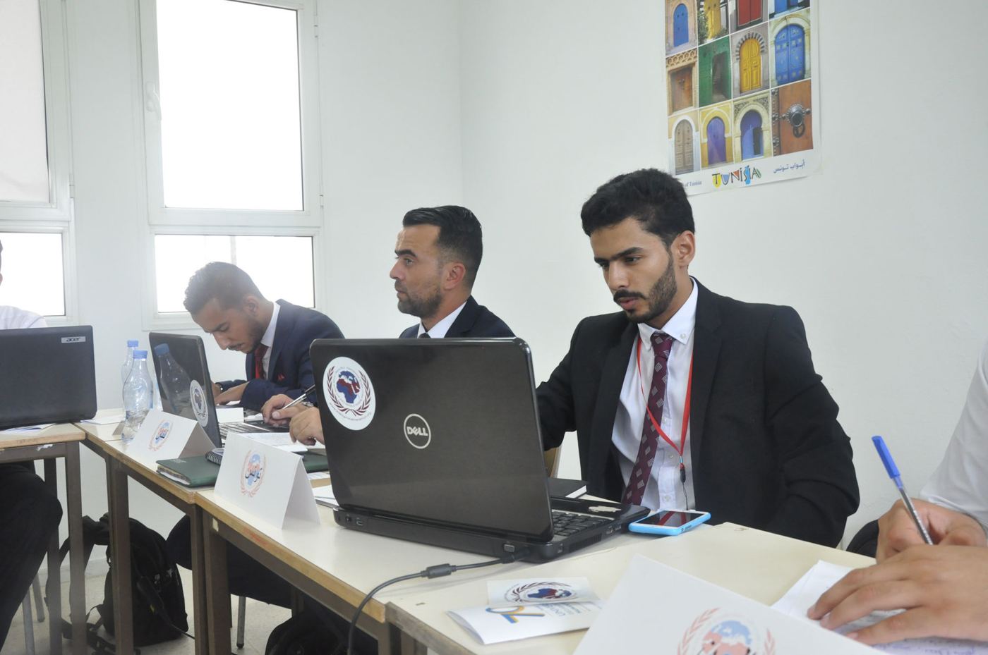 A participant taking notes at a laptop