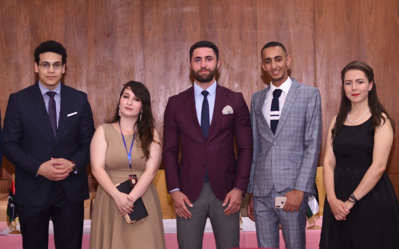 Five AOD members in formal dress at a conference
