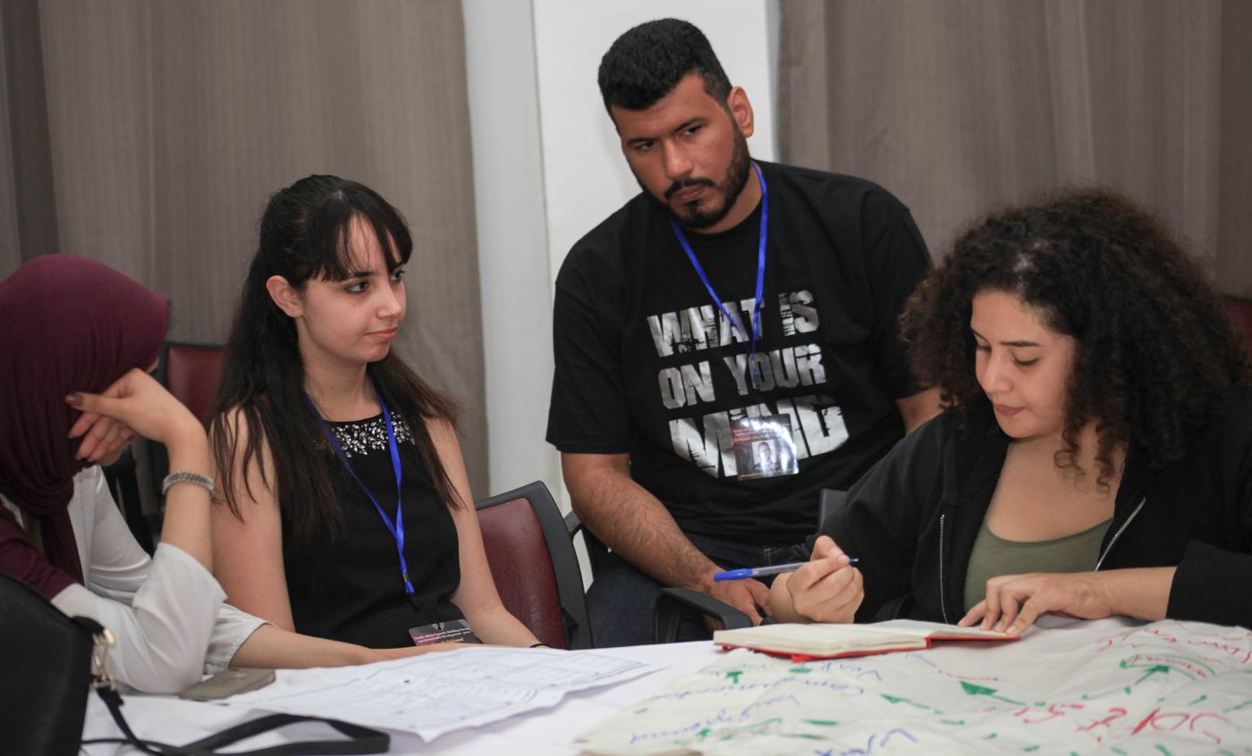 Forum participants working together on a flipchart