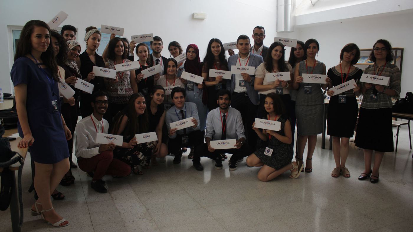 A training group holding name cards during an AOD programme