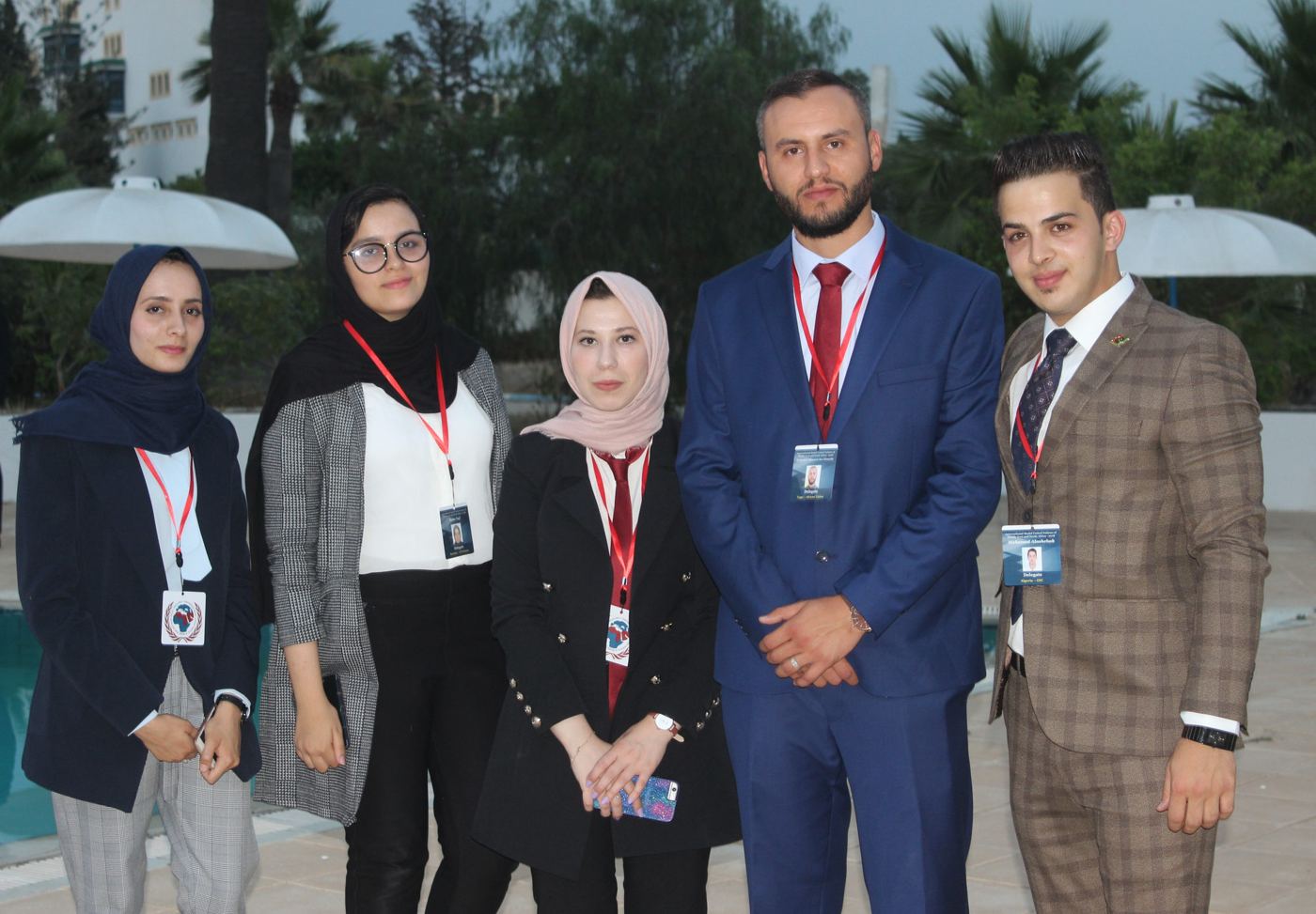 Five AOD members with conference badges standing together outdoors